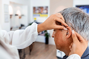 Man getting hearing aids fitted at Sunyview Hearing Center